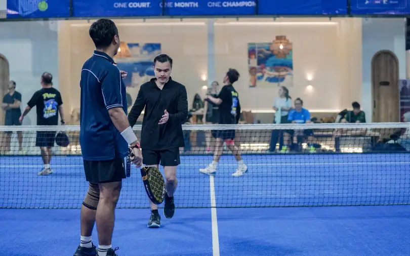Doubles players shaking hands at the net