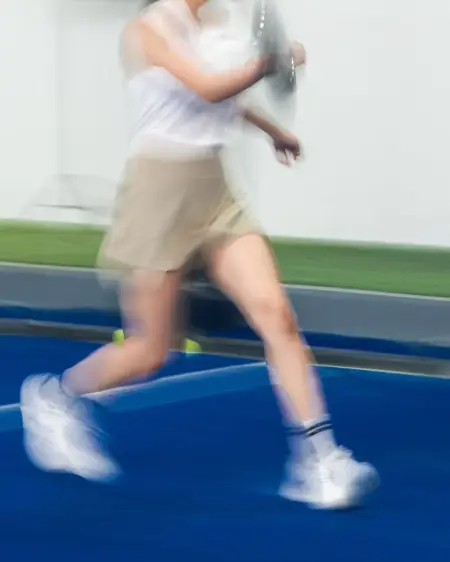 A player sprinting across the blue court