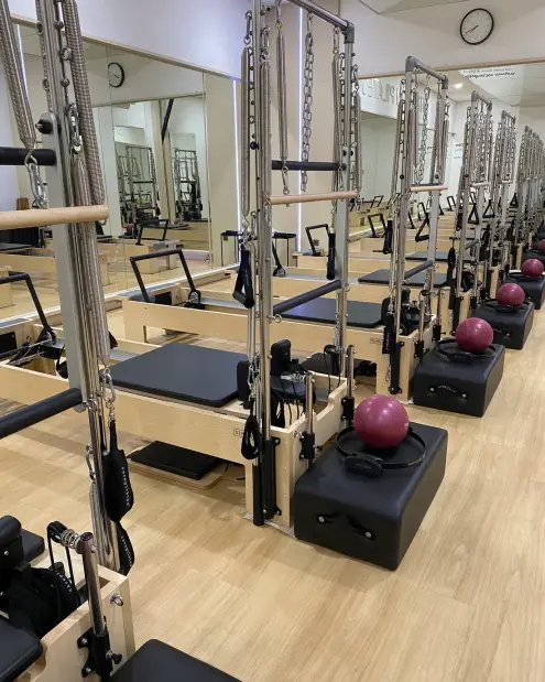 Row of reformer machines in the pilates studio